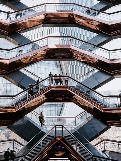 People walk in white and brown building
